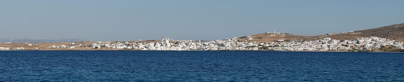 Panorama of a whitewashed Cycladic town across the bay, Paros